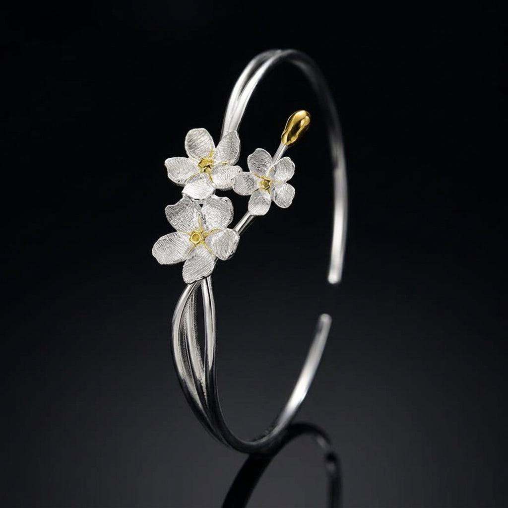 Handmade adjustable bangle for women in real 925 sterling silver featuring an elegant floral design with textured blossoms and an open cuff style.
