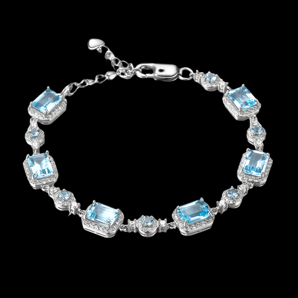 Silver bracelet with blue gemstones on a white background