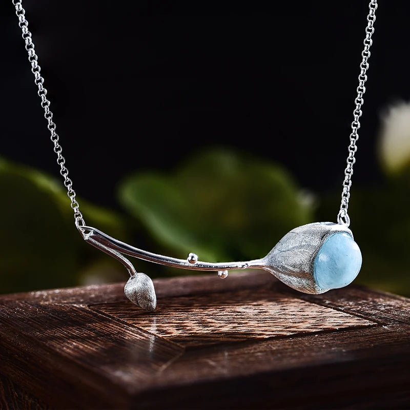 

925 sterling silver branch necklace featuring a natural aquamarine blue gemstone pendant on a delicate chain, available in gold blue stone and silver blue stone finishes.