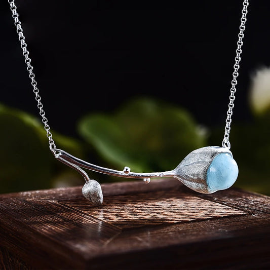 

925 sterling silver branch necklace featuring a natural aquamarine blue gemstone pendant on a delicate chain, available in gold blue stone and silver blue stone finishes.
