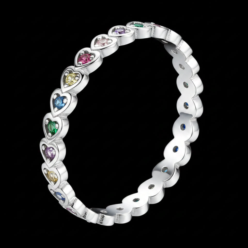 A silver heart-link eternity band bracelet with colorful gemstones, shown on a solid black background.