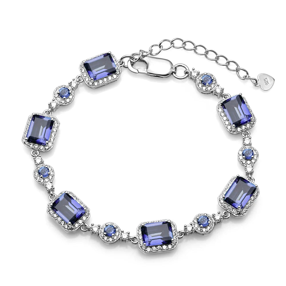 Silver bracelet with blue gemstones on a white background