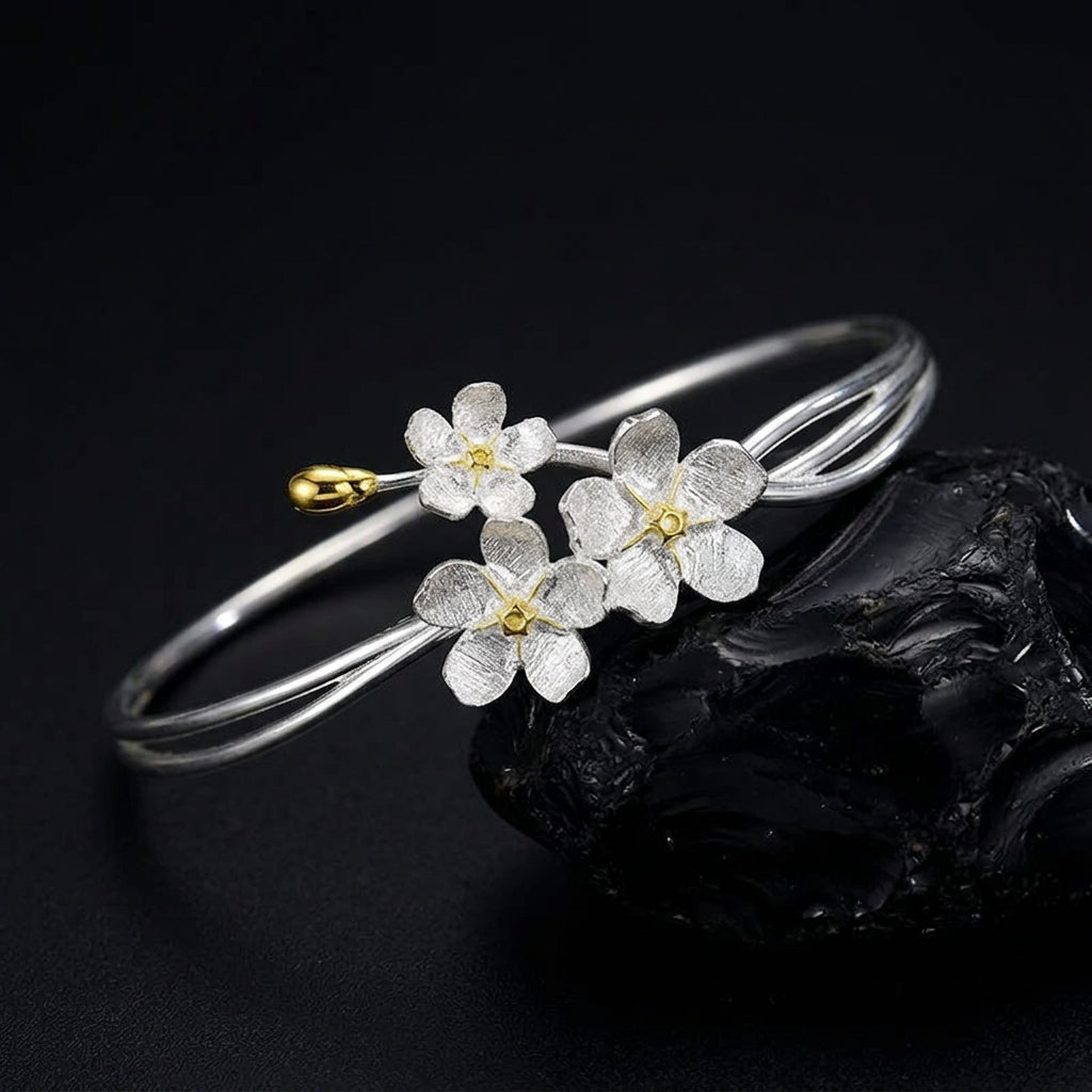 Handmade adjustable bangle for women in real 925 sterling silver featuring an elegant floral design with textured blossoms and an open cuff style.