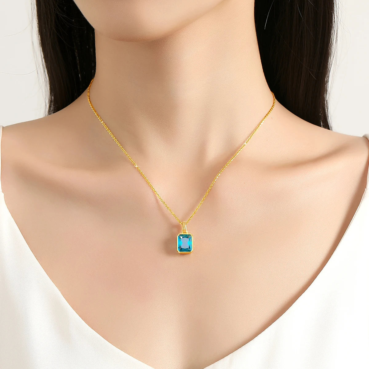 cubic zirconia pendant necklaces in blue elegant 18K gold-plated frames with matching gold chains.