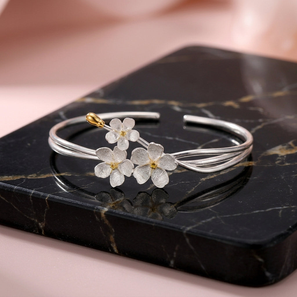 Handmade adjustable bangle for women in real 925 sterling silver featuring an elegant floral design with textured blossoms and an open cuff style.