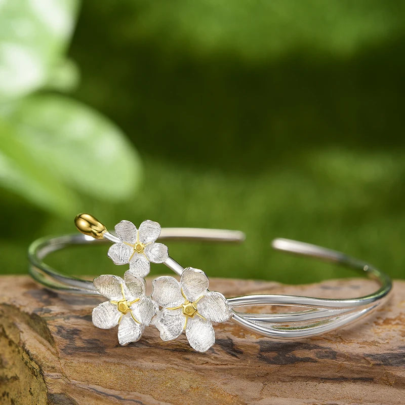 Handmade adjustable bangle for women in real 925 sterling silver featuring an elegant floral design with textured blossoms and an open cuff style.